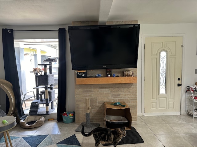 living room with beam ceiling and light tile patterned floors