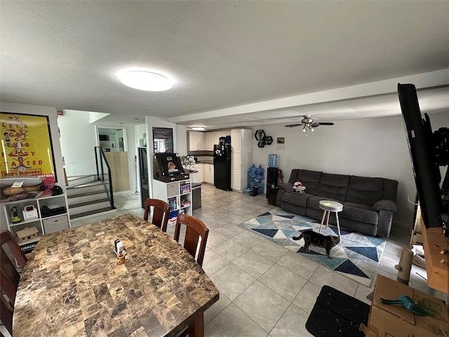 dining area with a textured ceiling and light tile patterned floors