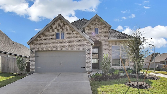 view of front facade with a front lawn and a garage