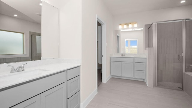 bathroom with tile patterned flooring, vanity, and a shower with door