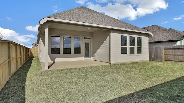 back of property with a lawn and a patio