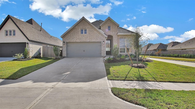 view of front of property with a garage and a front lawn