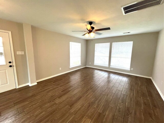 unfurnished room featuring ceiling fan and dark wood-type flooring