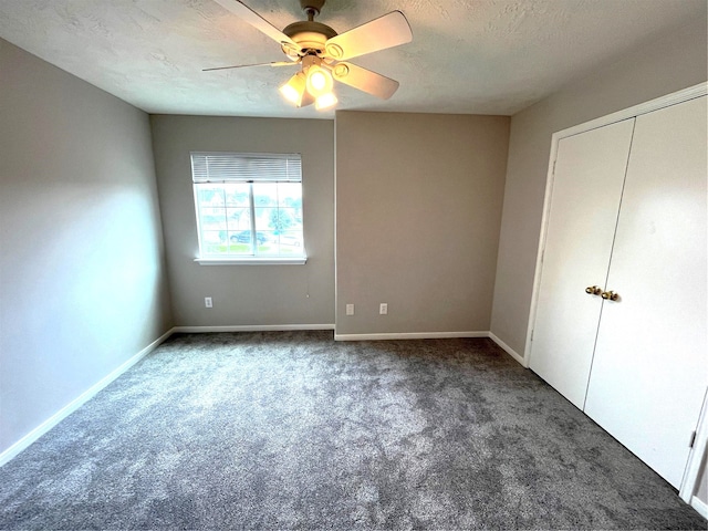 unfurnished bedroom featuring ceiling fan, carpet floors, and a textured ceiling