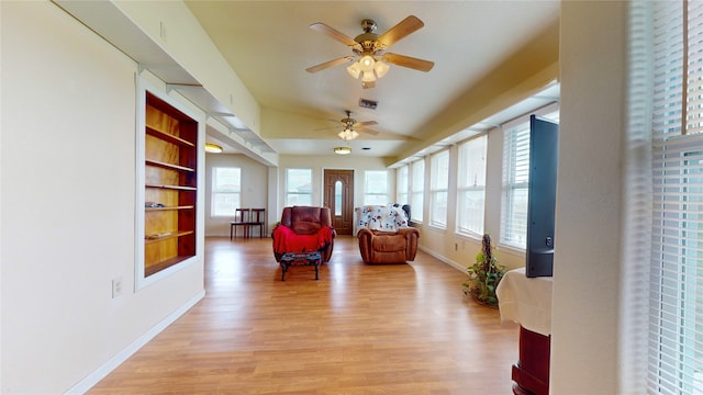 living area featuring light hardwood / wood-style flooring, a wealth of natural light, and ceiling fan