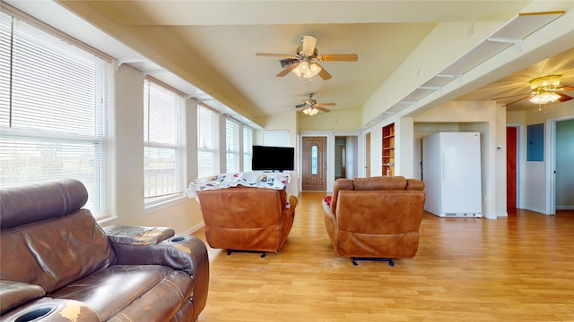 living room with light hardwood / wood-style floors, lofted ceiling, and ceiling fan