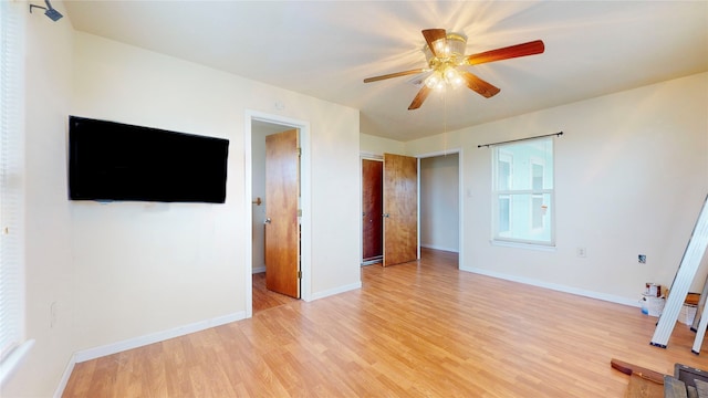 unfurnished bedroom with ceiling fan and light hardwood / wood-style flooring