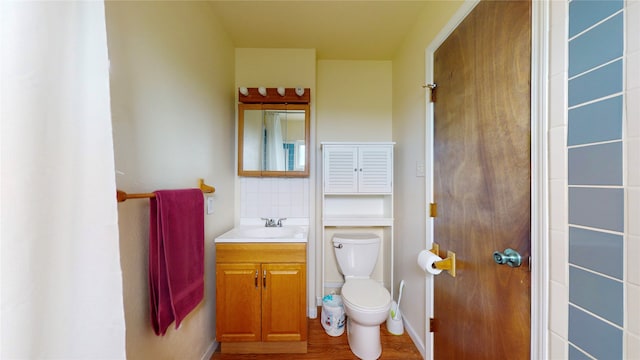 bathroom featuring hardwood / wood-style flooring, vanity, and toilet