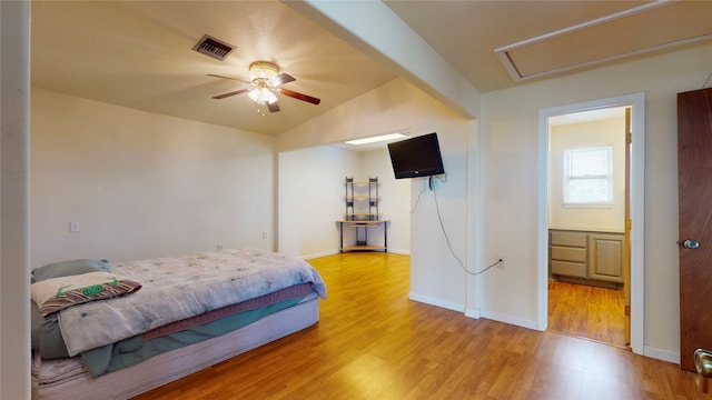 bedroom featuring ceiling fan, light hardwood / wood-style flooring, and vaulted ceiling