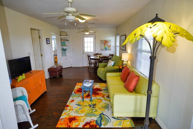 living room with ceiling fan and dark hardwood / wood-style floors