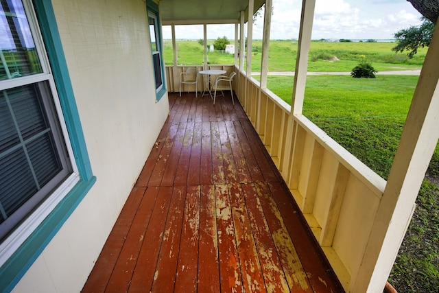 wooden deck featuring a lawn