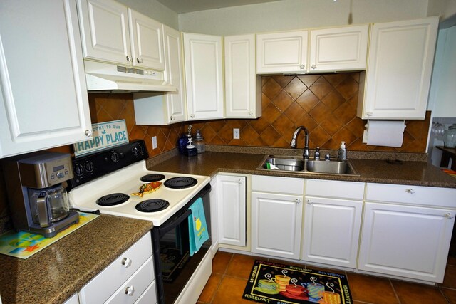 kitchen featuring white electric range, backsplash, sink, and white cabinetry