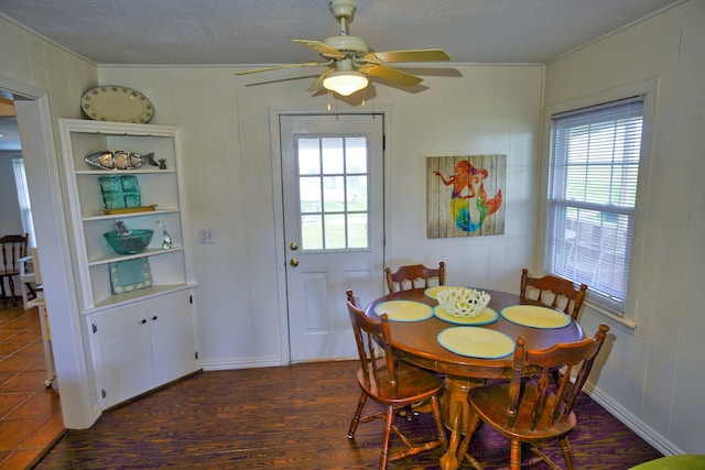 dining area featuring ceiling fan, a textured ceiling, dark hardwood / wood-style flooring, and a wealth of natural light