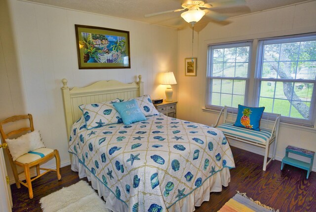 bedroom featuring ceiling fan and dark hardwood / wood-style flooring