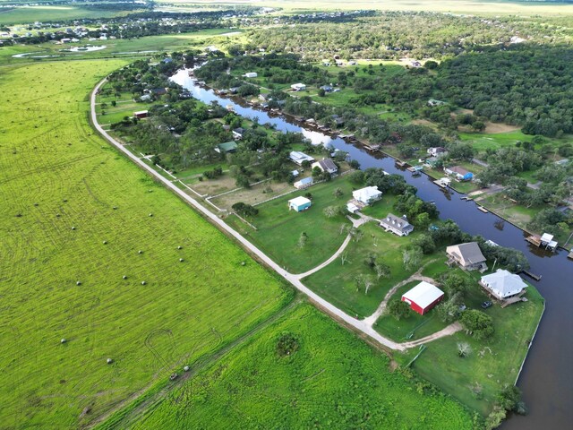 bird's eye view with a water view and a rural view