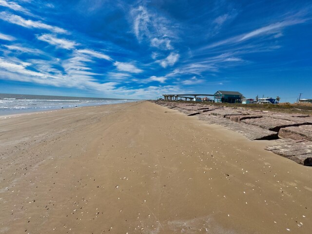 view of street featuring a water view and a view of the beach