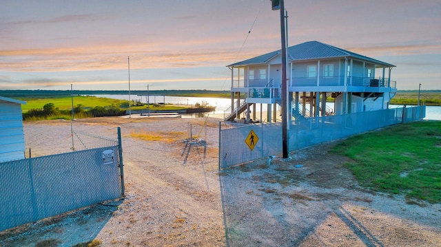 4850 County Road 328, Vanderbilt, TX 77969 - exterior space with metal roof, a water view, fence, and stairway
