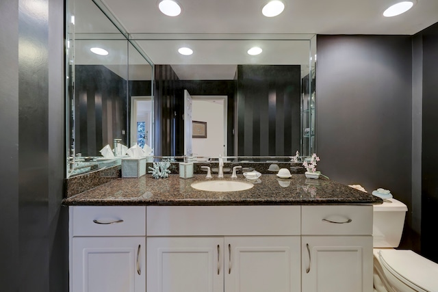 bathroom featuring toilet and vanity