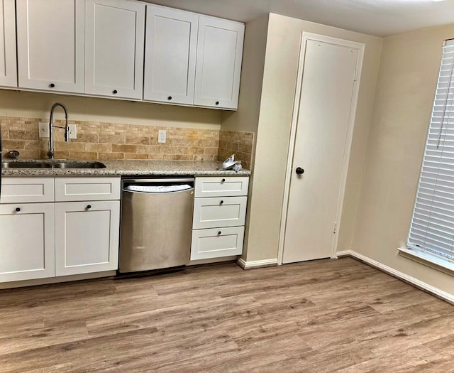 kitchen featuring white cabinets, dishwasher, light hardwood / wood-style floors, and sink