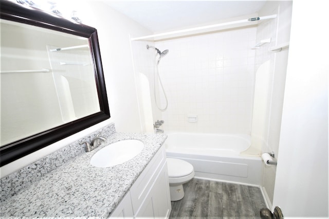 full bathroom featuring tiled shower / bath combo, vanity, toilet, and hardwood / wood-style flooring