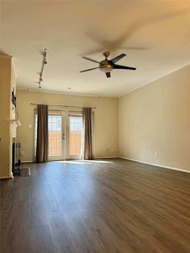 unfurnished living room featuring crown molding, dark wood-type flooring, ceiling fan, and rail lighting