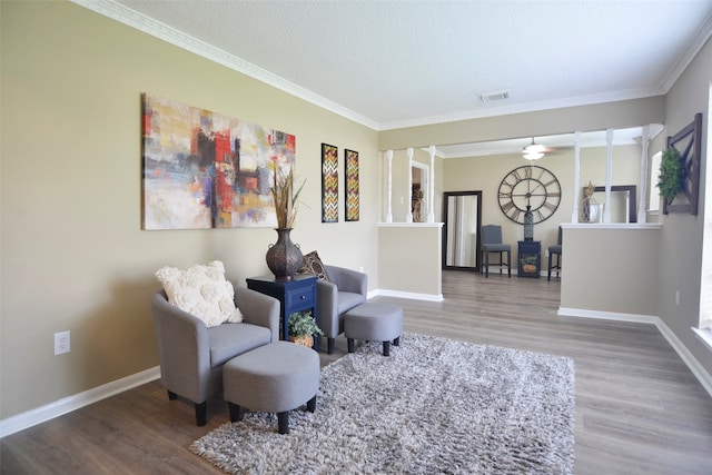 living area featuring hardwood / wood-style floors and crown molding