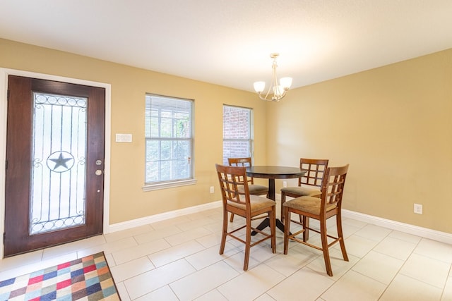 tiled dining room with a chandelier