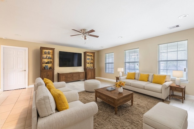 living room featuring ceiling fan and light tile patterned floors