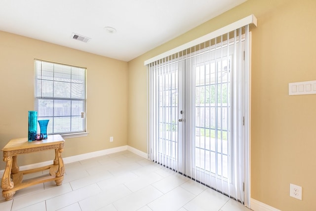 doorway to outside with french doors and light tile patterned flooring