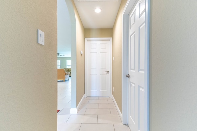 corridor featuring light tile patterned floors