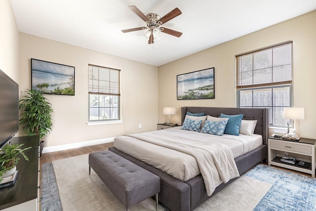 bedroom with ceiling fan and wood-type flooring