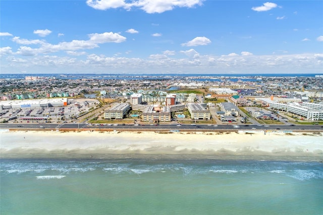 bird's eye view featuring a view of the beach and a water view