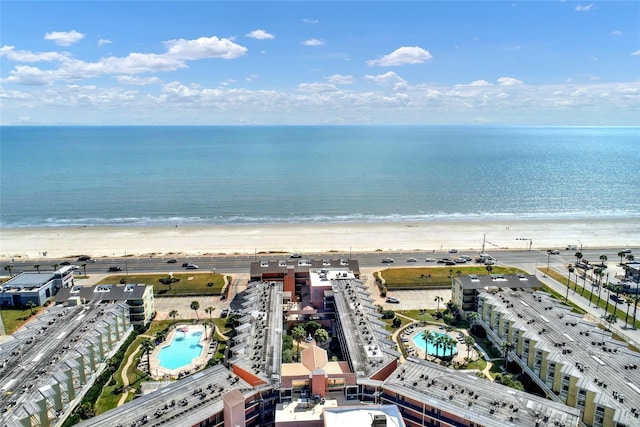 birds eye view of property with a view of the beach and a water view