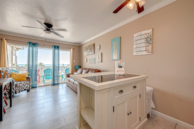 interior space featuring ceiling fan, light tile patterned floors, a textured ceiling, and ornamental molding