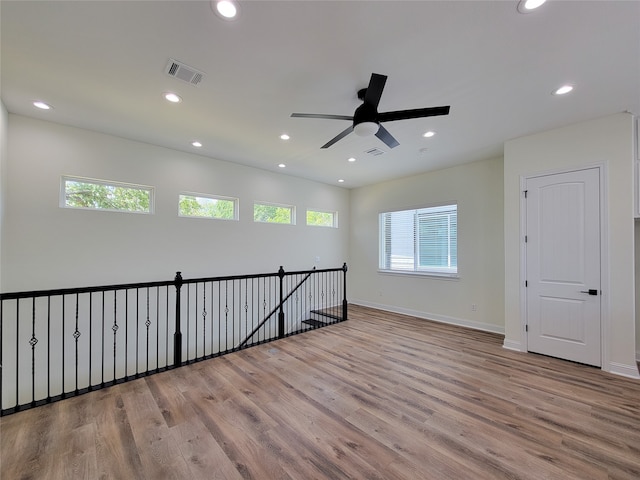 spare room with ceiling fan and light hardwood / wood-style floors