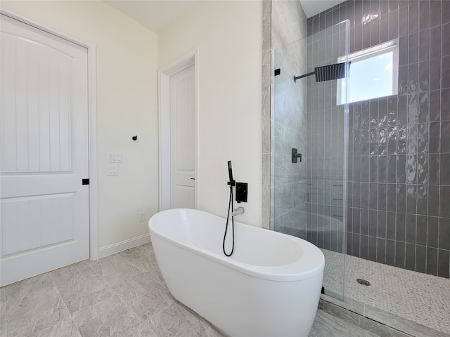 bathroom featuring shower with separate bathtub