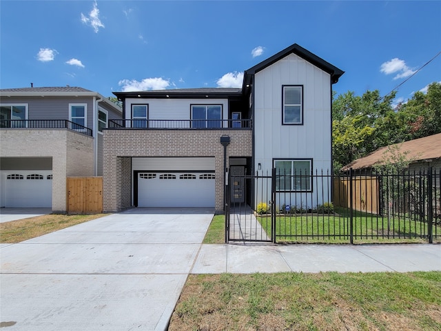 view of front of property with a balcony, a garage, and a front yard