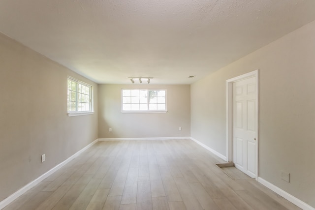 spare room featuring light wood-type flooring