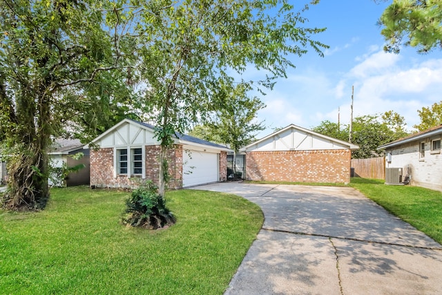 view of front of home featuring a garage, a front lawn, and central AC