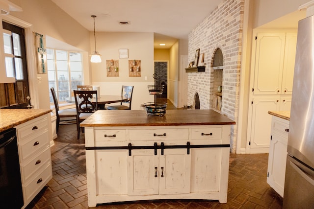 kitchen with stainless steel fridge, white cabinetry, dishwasher, pendant lighting, and wood counters