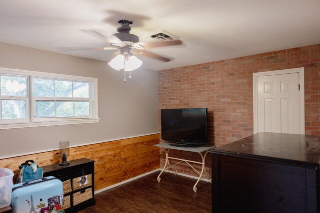 interior space with wood walls, ceiling fan, and dark hardwood / wood-style floors