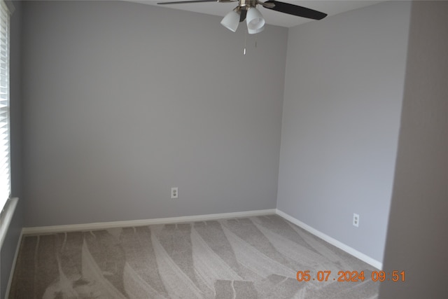 carpeted empty room with ceiling fan