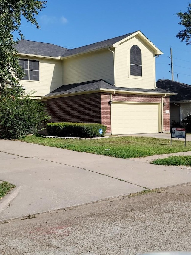 traditional-style house featuring brick siding, concrete driveway, and a garage