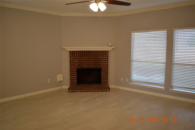 unfurnished living room featuring ceiling fan, a fireplace, and crown molding