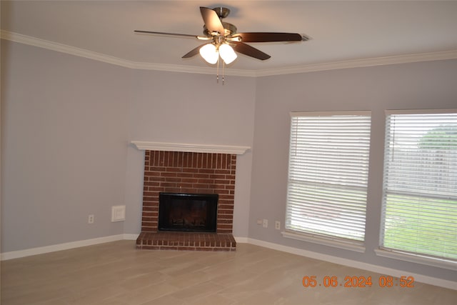 unfurnished living room featuring ornamental molding, light wood-type flooring, ceiling fan, and a fireplace