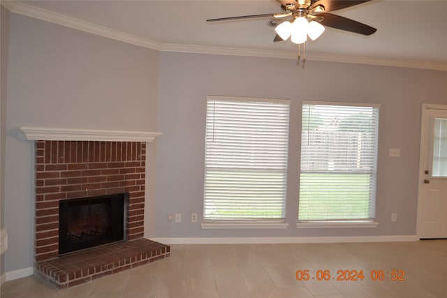 unfurnished living room with ceiling fan, a fireplace, ornamental molding, and a healthy amount of sunlight