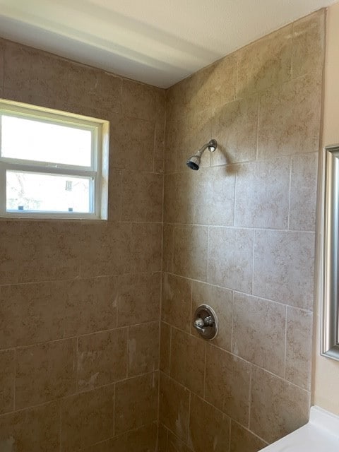 bathroom with a tile shower