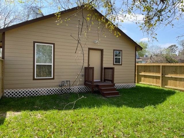 rear view of house with a lawn