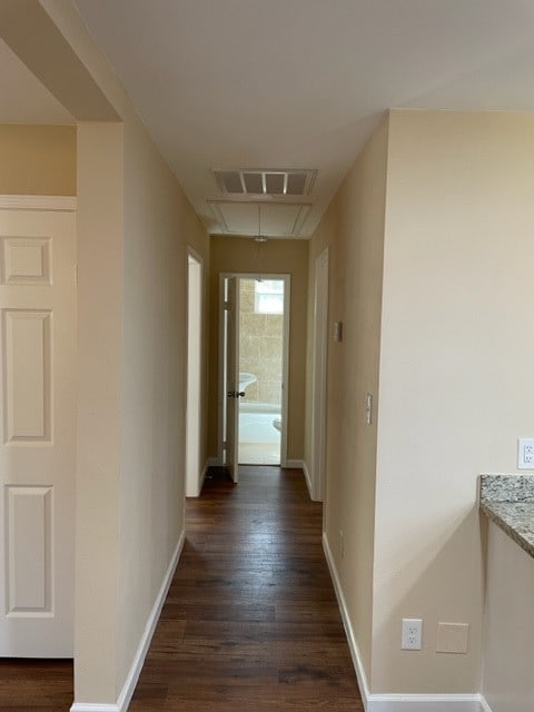 hallway with dark hardwood / wood-style floors