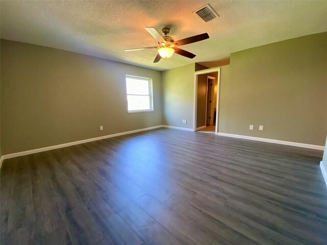 8922 Glacier Ave, Texas City, TX 77591 - unfurnished room with dark wood-type flooring, baseboards, a textured ceiling, visible vents, and a ceiling fan